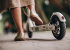 young-woman-riding-scooter-in-park-feet-close-up.jpg